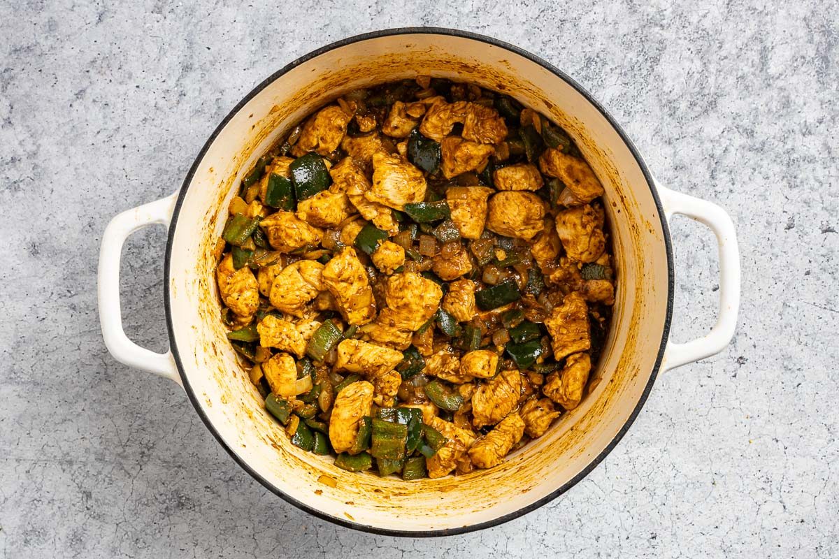 Taste of Home Chicken Poblano Soup photo of the chicken and seasonings added to the Dutch oven.