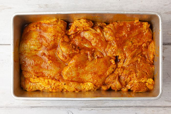 Step 3 of Taste of Home Chicken Shawarma is to laye hte chicken in a loaf pan and bake it