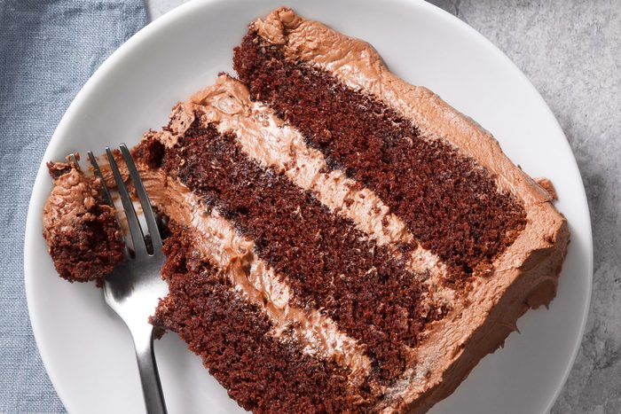 close up view of the texture of a slice of chocolate cake with a fork removing a piece