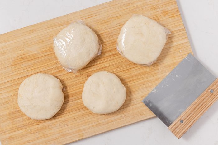 Dough for chocolate rugelach divided and wrapped into four disks to go in the fridge.