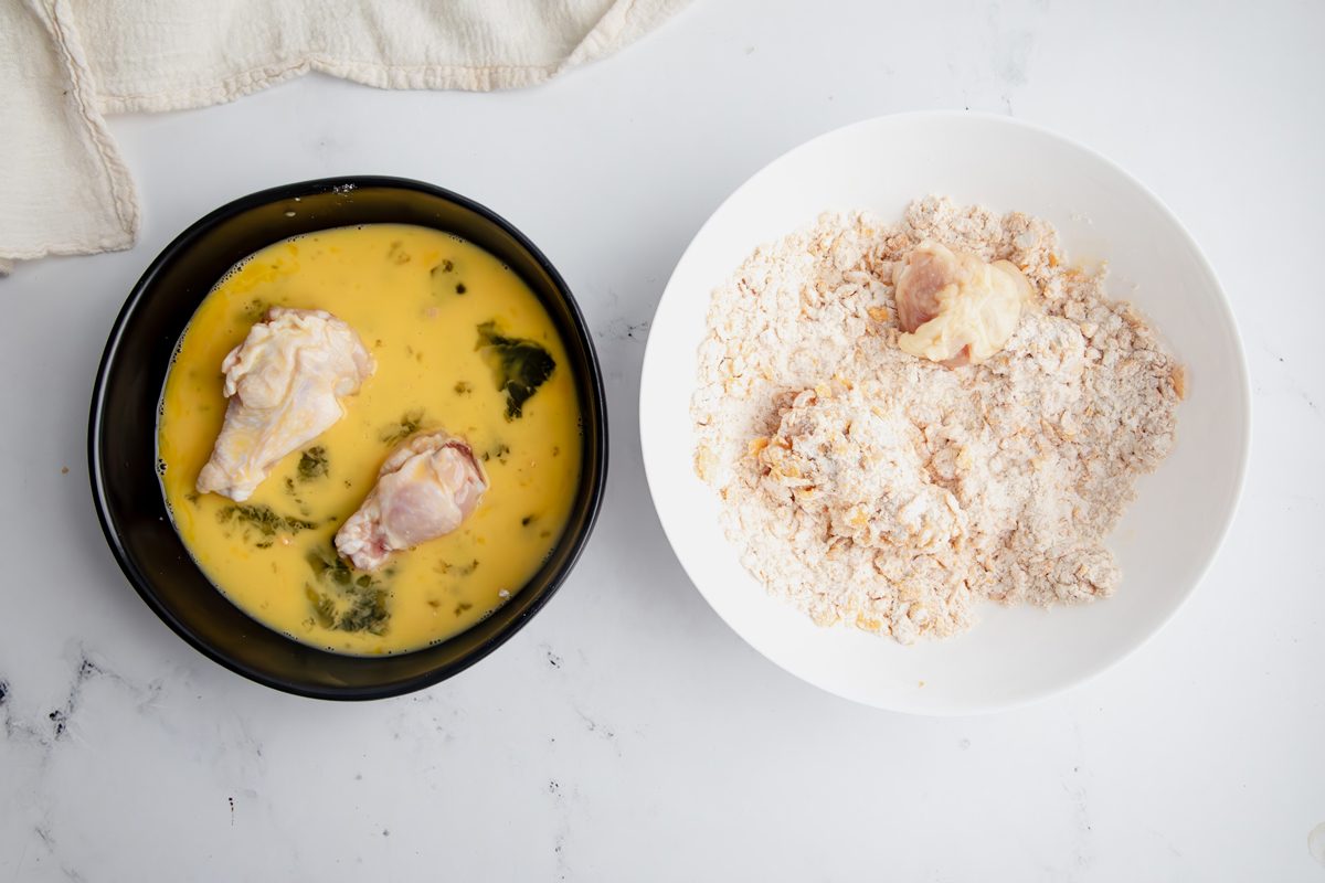 Overhead shot for Taste of Home Cornflake Chicken, coating the chicken in mixture.