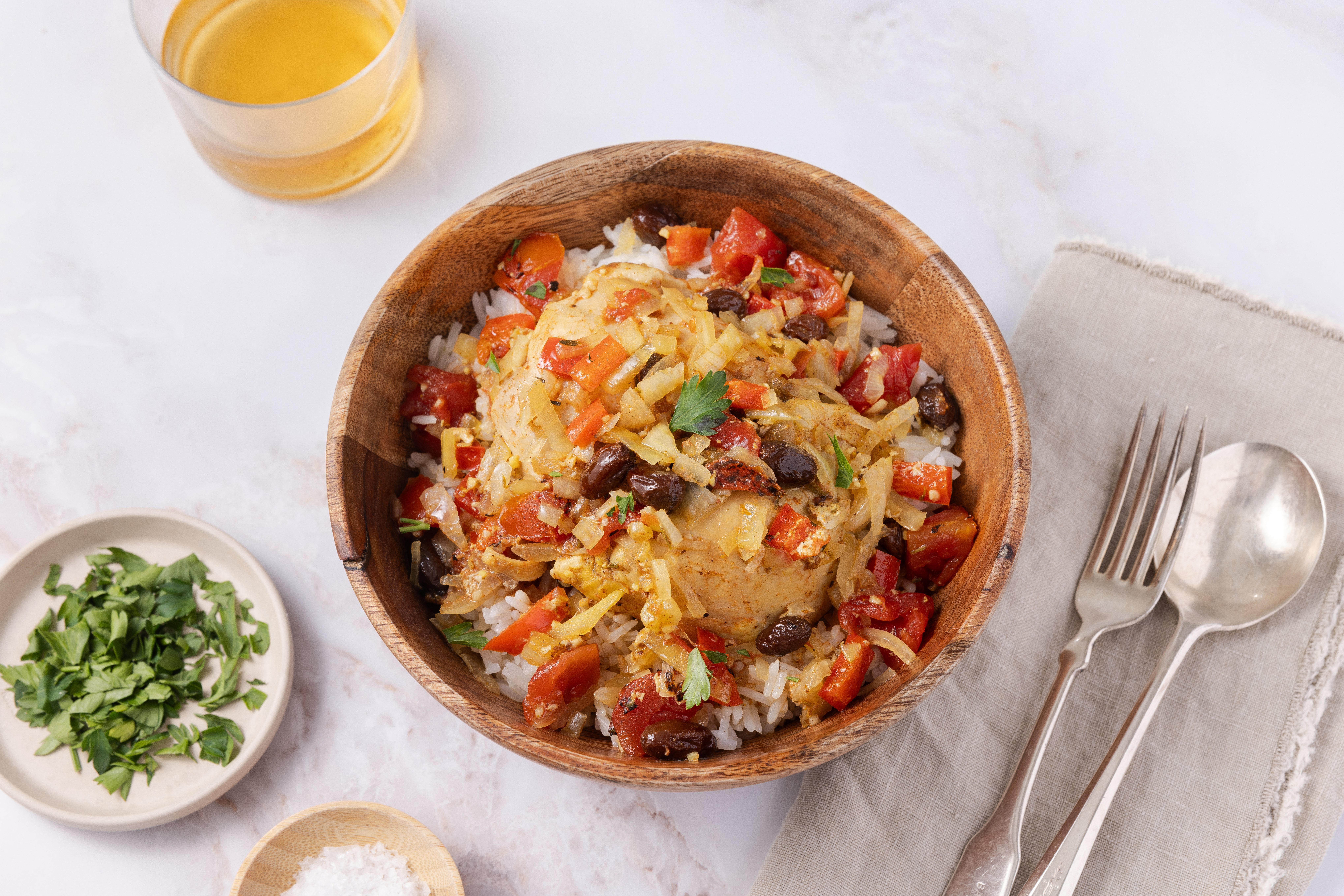 Country captain chicken ready and served in wood bowl with rice.