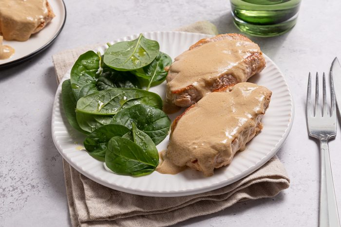 Plate With Cream Cheese Pork Tenderloin Chops And Green Salad