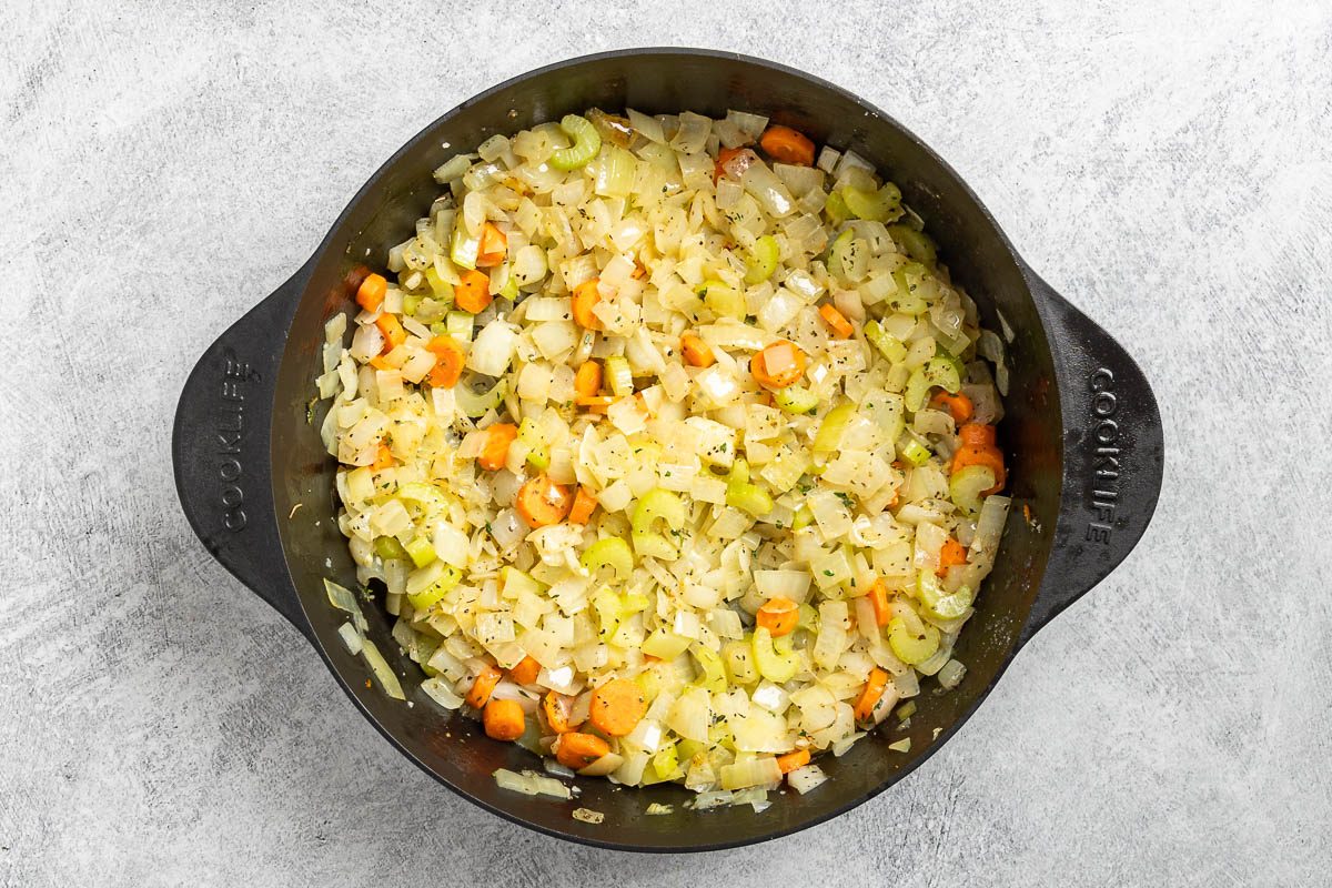 Taste of Home Cream of Onion Soup photo of the sauteed onion, celery, carrots, seasonings and garlic in a Dutch oven.