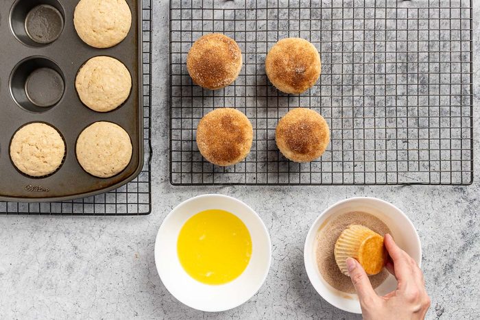 dipping the baked muffins in butter, then in cinnamon sugar.