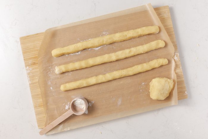Almond filling being rolled into 12x1/2-inch ropes.