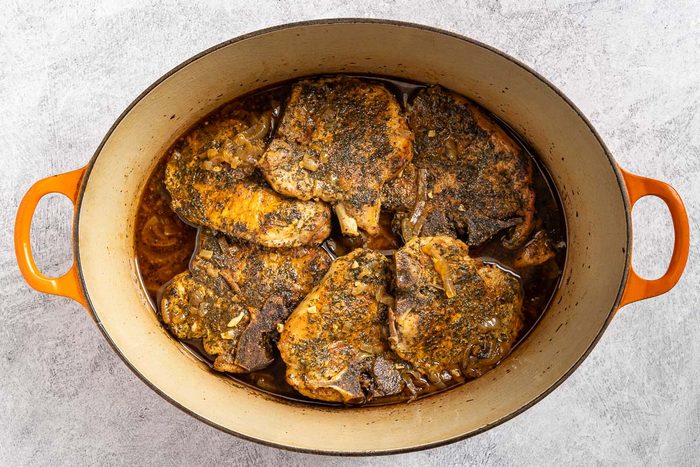 Taste of Home Dutch Oven Pork Chops photo of the braised pork chops in the Dutch oven.