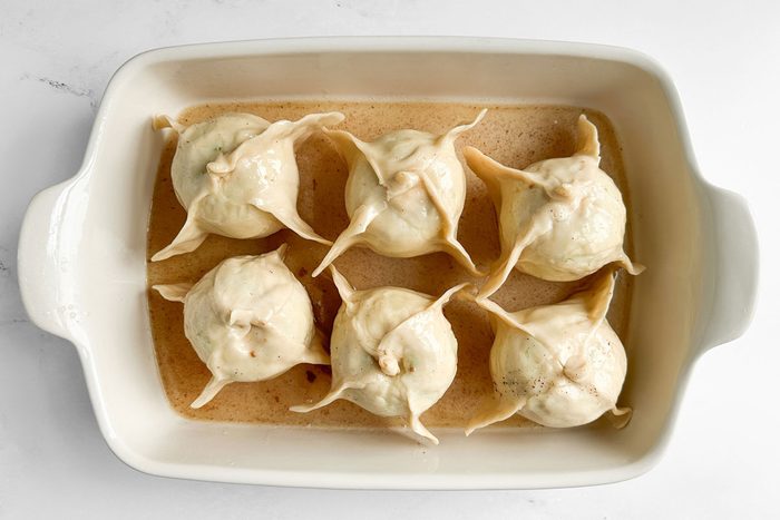 Unbaked Taste of Home Easy Apple Dumplings in a white baking pan