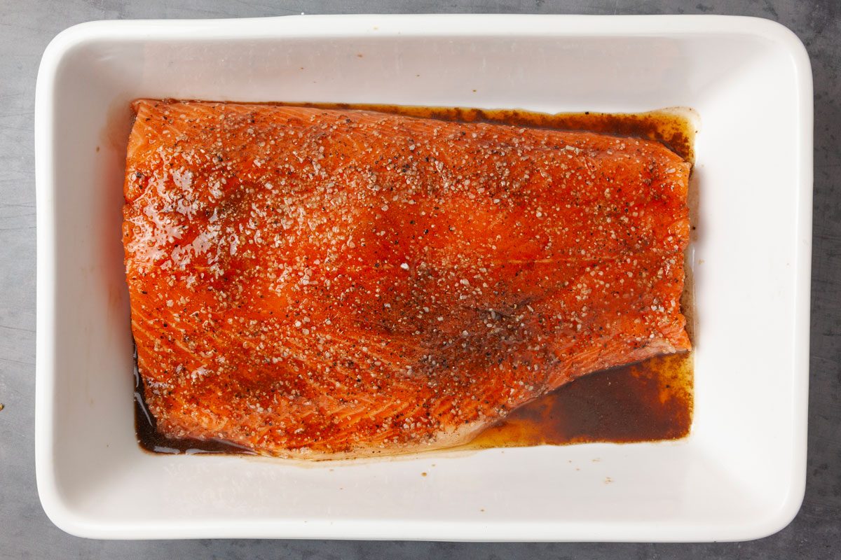 Step 1 of Taste of Home Smoked Salmon is to Place the salmon skin side down in an 11x7-inch baking pan coated with cooking spray. Sprinkle with brown sugar, salt and pepper. Drizzle with the liquid smoke. Cover and refrigerate the salmon for four to eight hours.