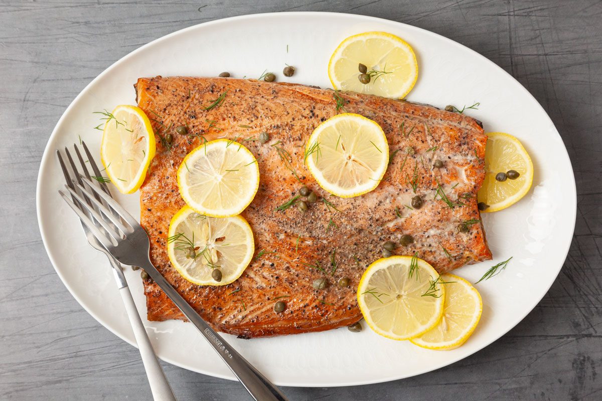 Full yield of Taste of Home Smoked Salmon garnished with lemon slices and capers