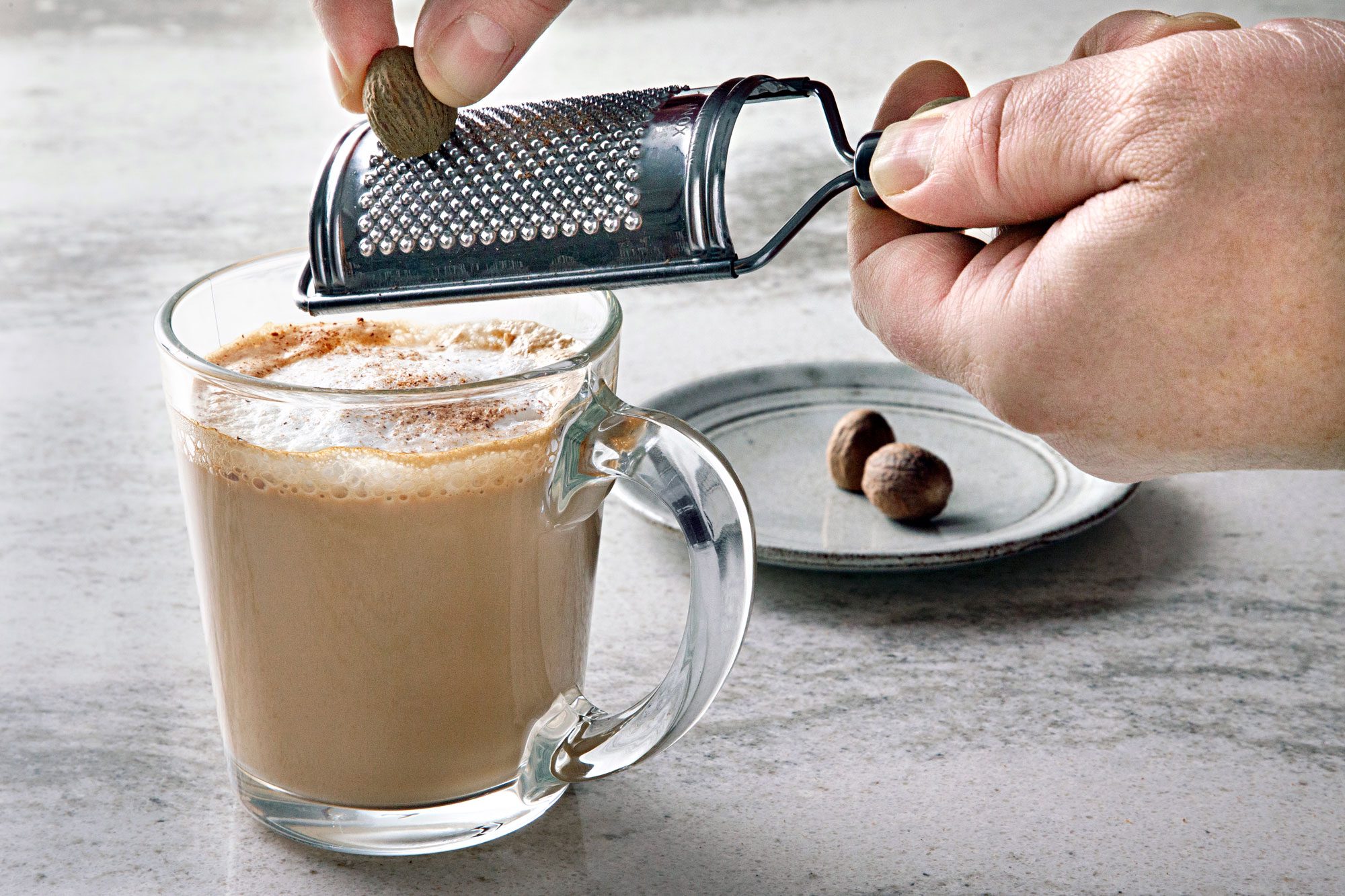 Grating nutmeg over the cup