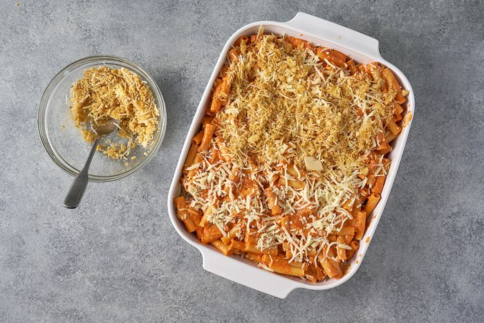In a small bowl, mix together Parmesan, panko bread crumbs, garlic, and olive oil to prepare the crispy topping. Evenly sprinkle the mixture over the Five-Cheese Ziti before baking.