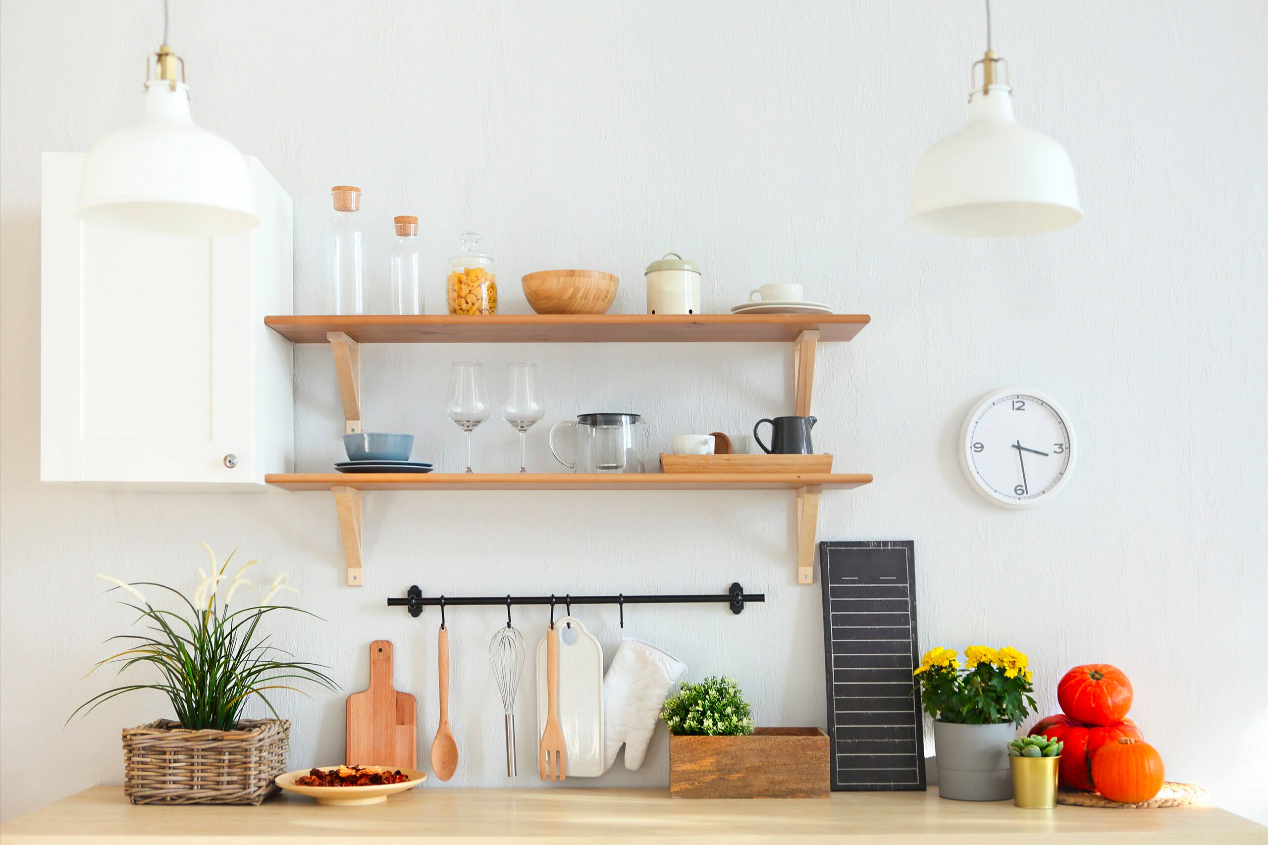 Interior of empty modern white kitchen with various objects