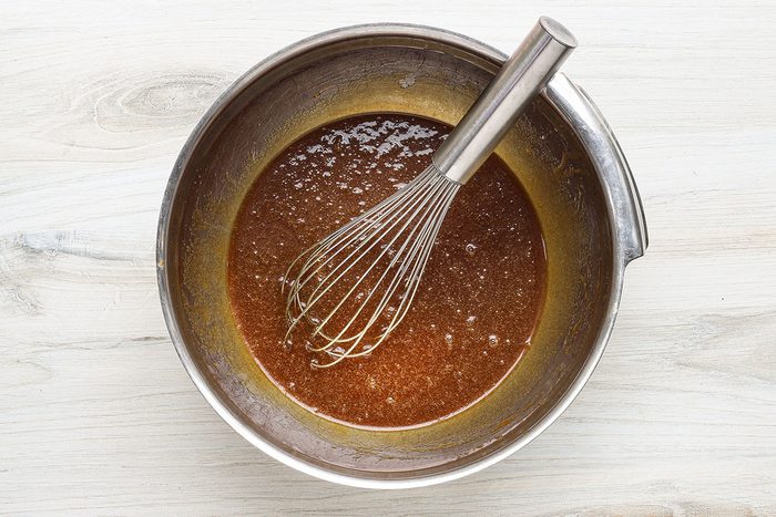 Combining the sugar, molasses, butter, and eggs for gingerbread blondies.