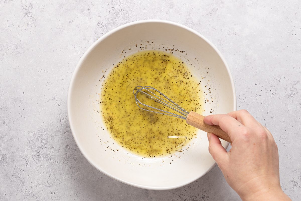 Olive Oil, Lemon Juice, Salt And Pepper Mixed Inside Bowl