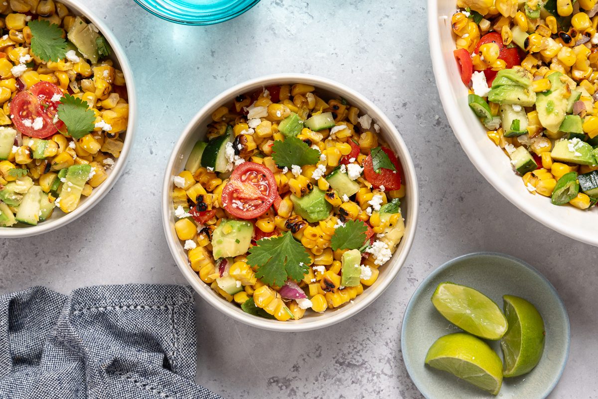 Grilled Corn Salad Inside Bowls With Lime