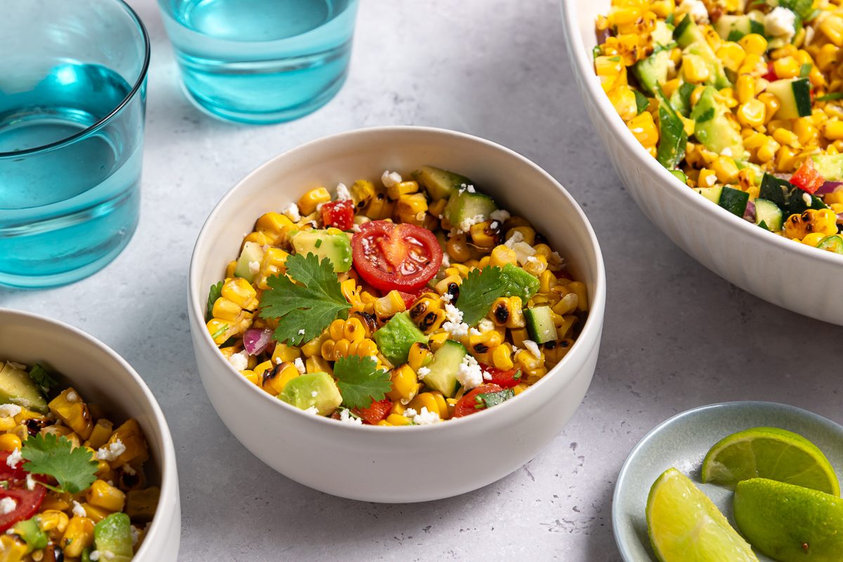Grilled Corn Salad Inside Bowls With Lime