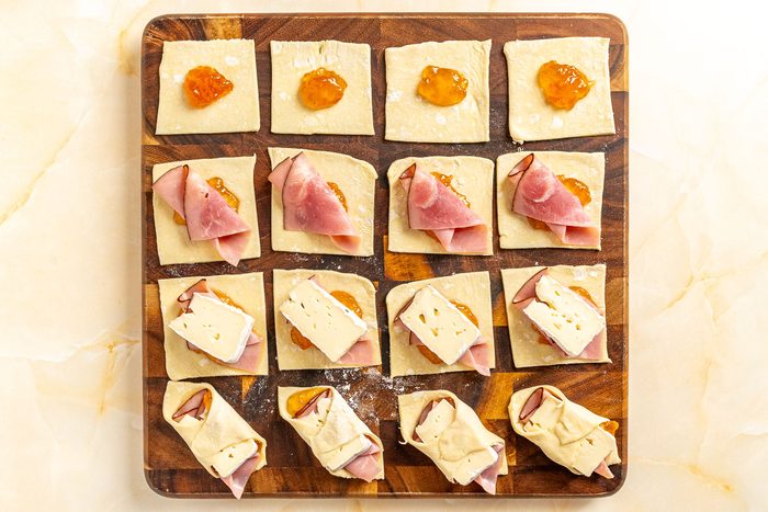 Taste of Home Ham and Cheese Puff Pastry photo of assembling the pastries.