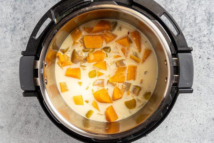 Taste of Home Butternut Squash Soup photo of coconut milk added to the cooked ingredients.