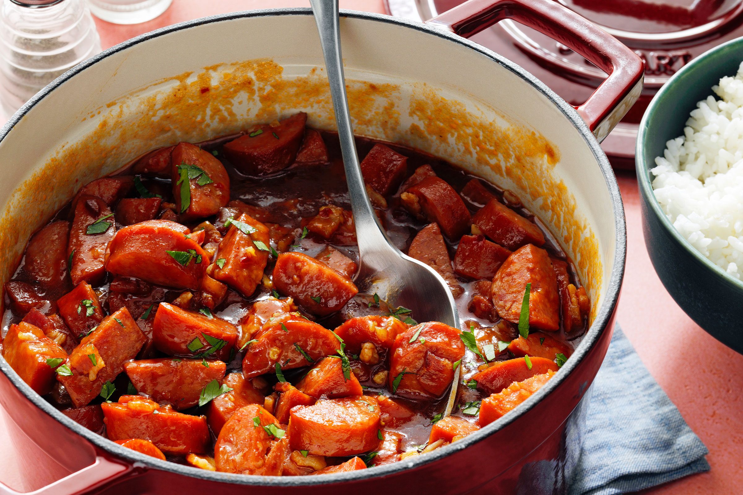 A bowl of Keilbasa served with white rice on a counter