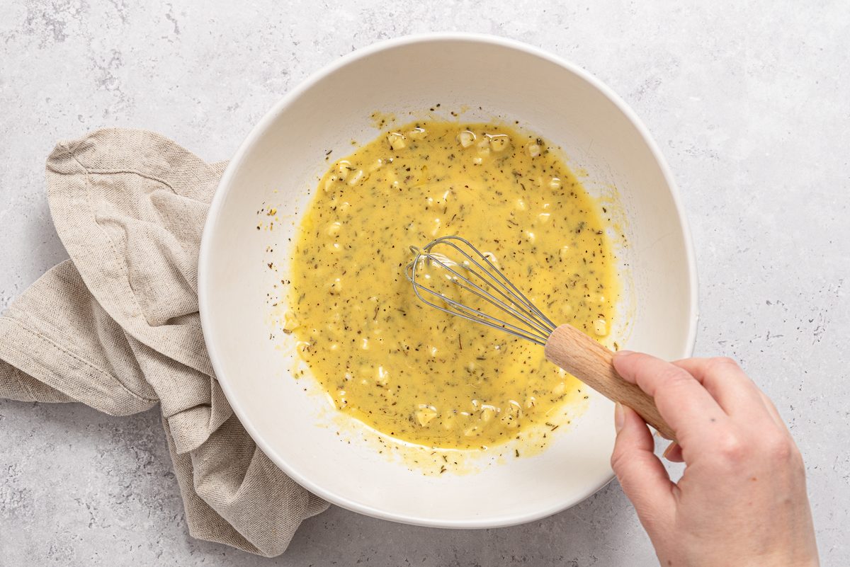 Garlic, Herbs, Mustard, Lemon And Oil Mixed Inside Bowl