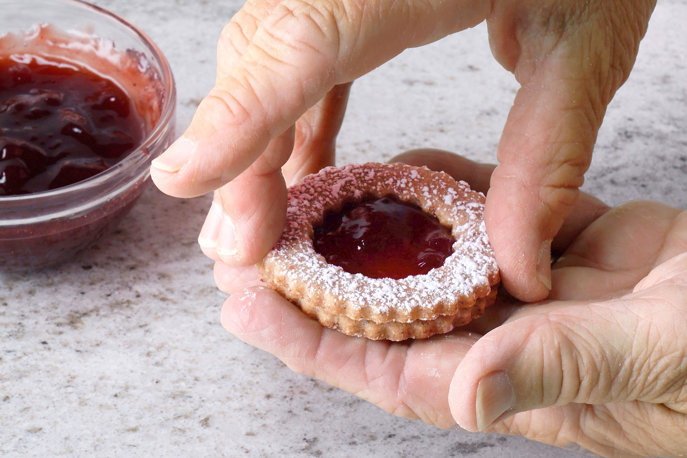 Sandwiched Linzer Cookies with jam is centre