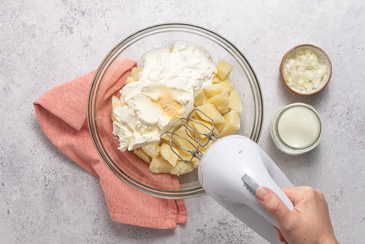 Handmixer Beating Ingredients For Mashed Potato Casserole