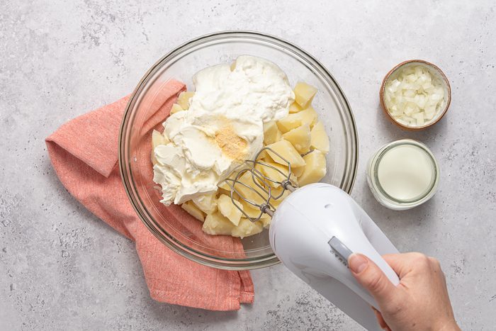 Handmixer Beating Ingredients For Mashed Potato Casserole
