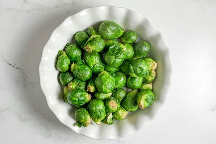 Taste of Home Microwave Brussels Sprouts in a white ceramic dish