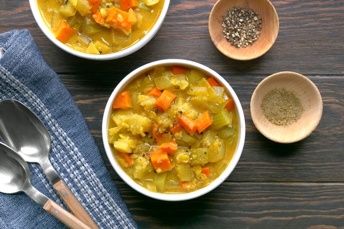 Mulligatawny Soup served in a bowl with spices on side
