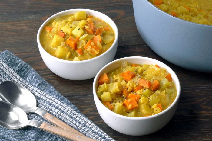 Mulligatawny Soup served in white bowls with spoons on side