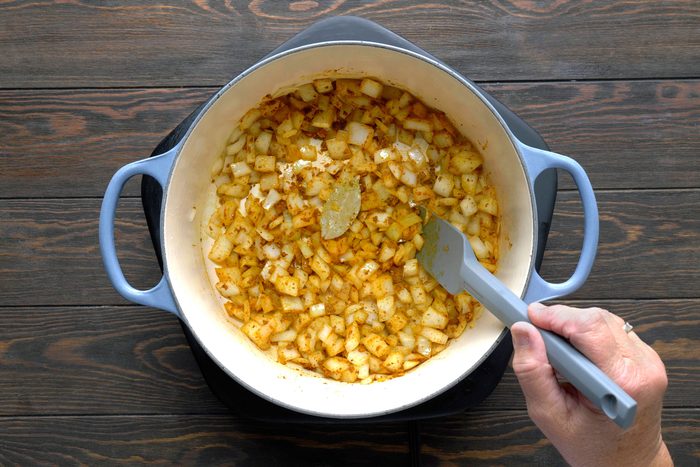 Onion, curry paste and bay leaf cooking in ghee