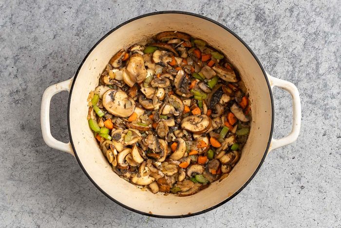 Taste of Home Mushroom Barley Soup reciped photo of adding the mushrooms and seasonings.