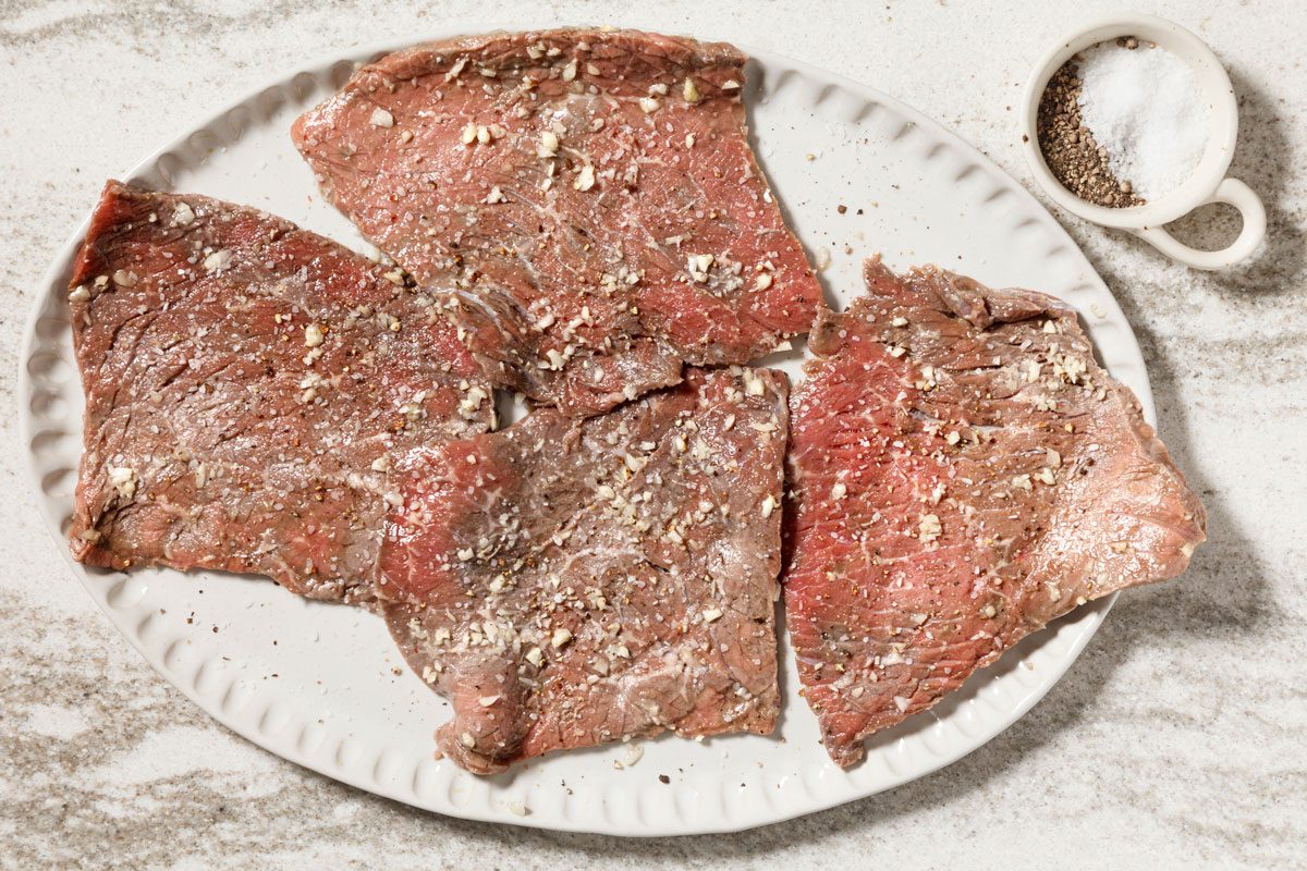 seasoned steaks on a platter