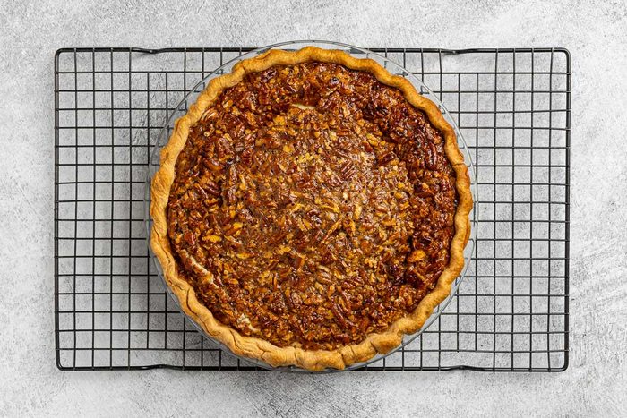 baked cheesecake cooling on a rack.