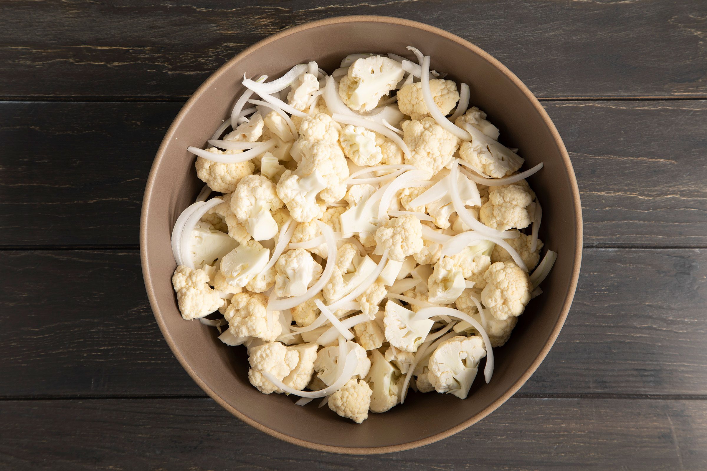 A bowl of cut cauliflower and onions