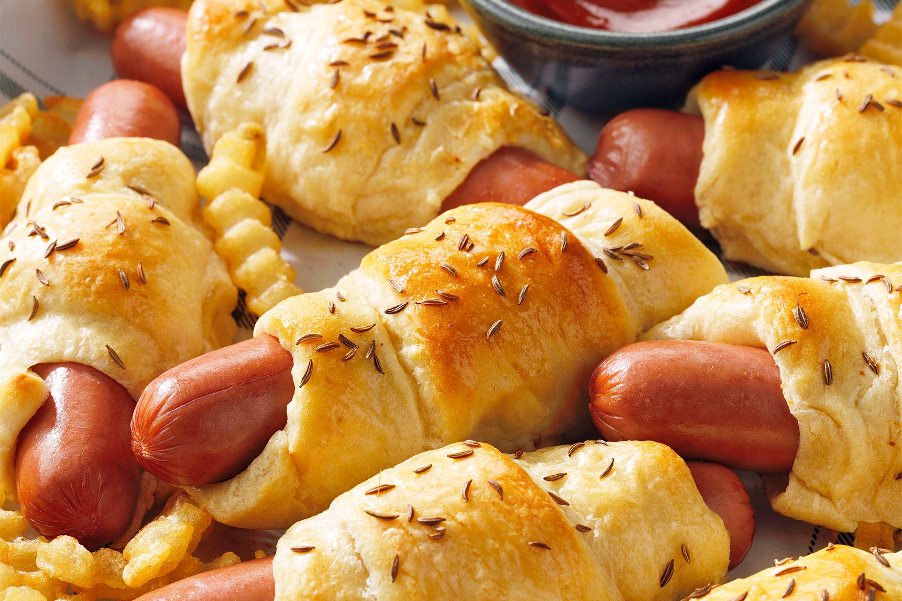 close shot of pigs in blanket with ketchup