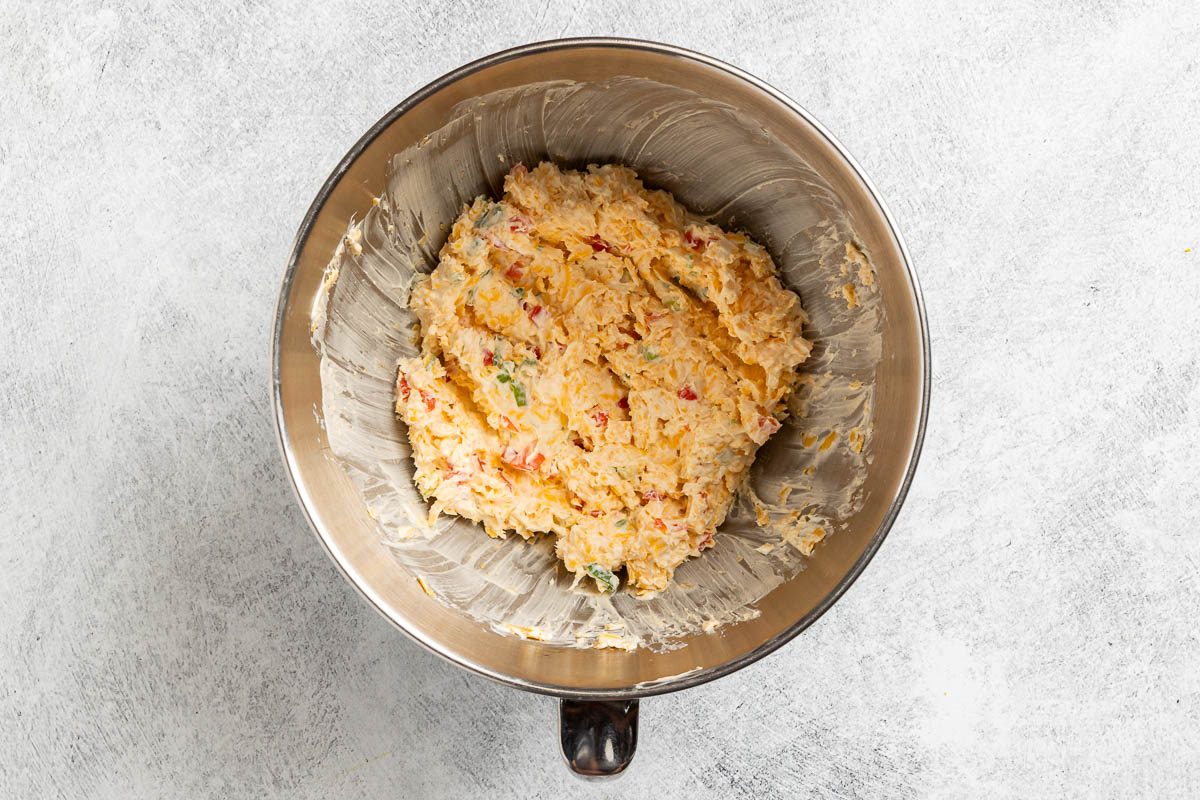 Taste of Home Pimento Cheese Ball photo of mixing the ingredients in a mixing bowl.