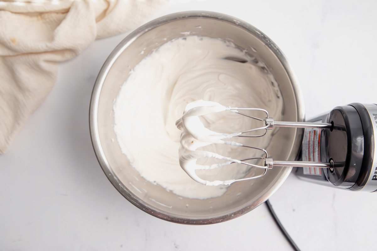 Overhead shot for Taste of Home Pink Cupcakes, white chocolate frosting being made.