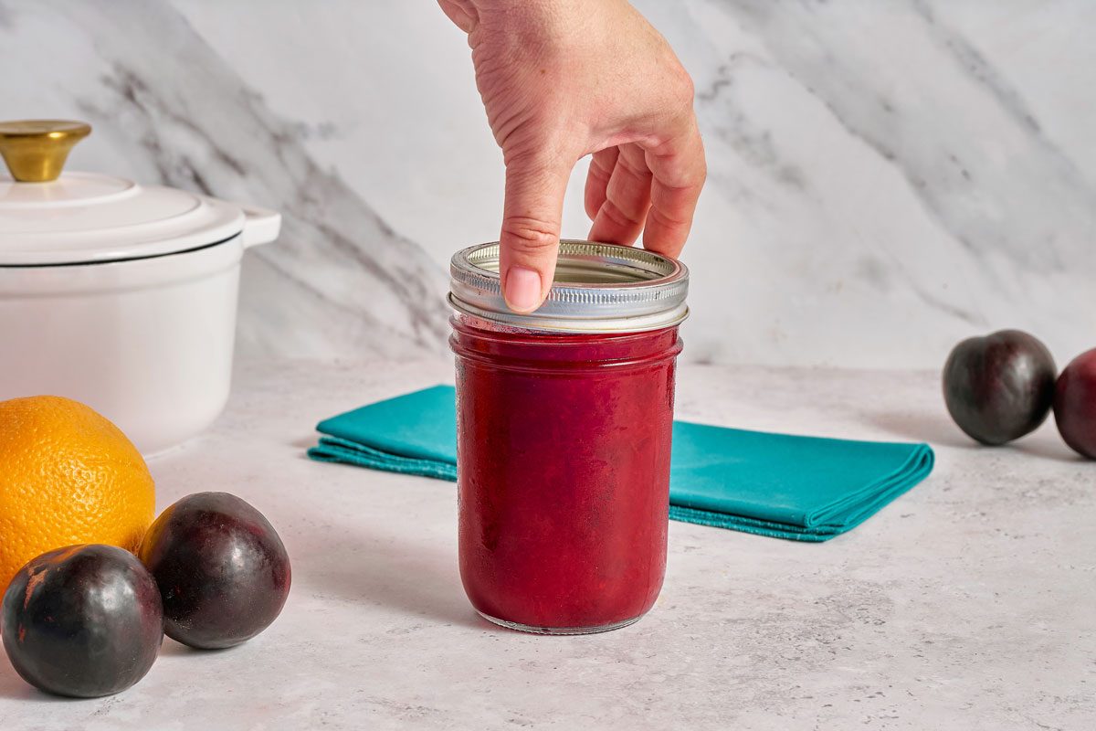 putting lid on jam jar