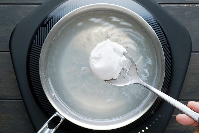 Use a slotted spoon to carefully lift the poached egg out of the water.