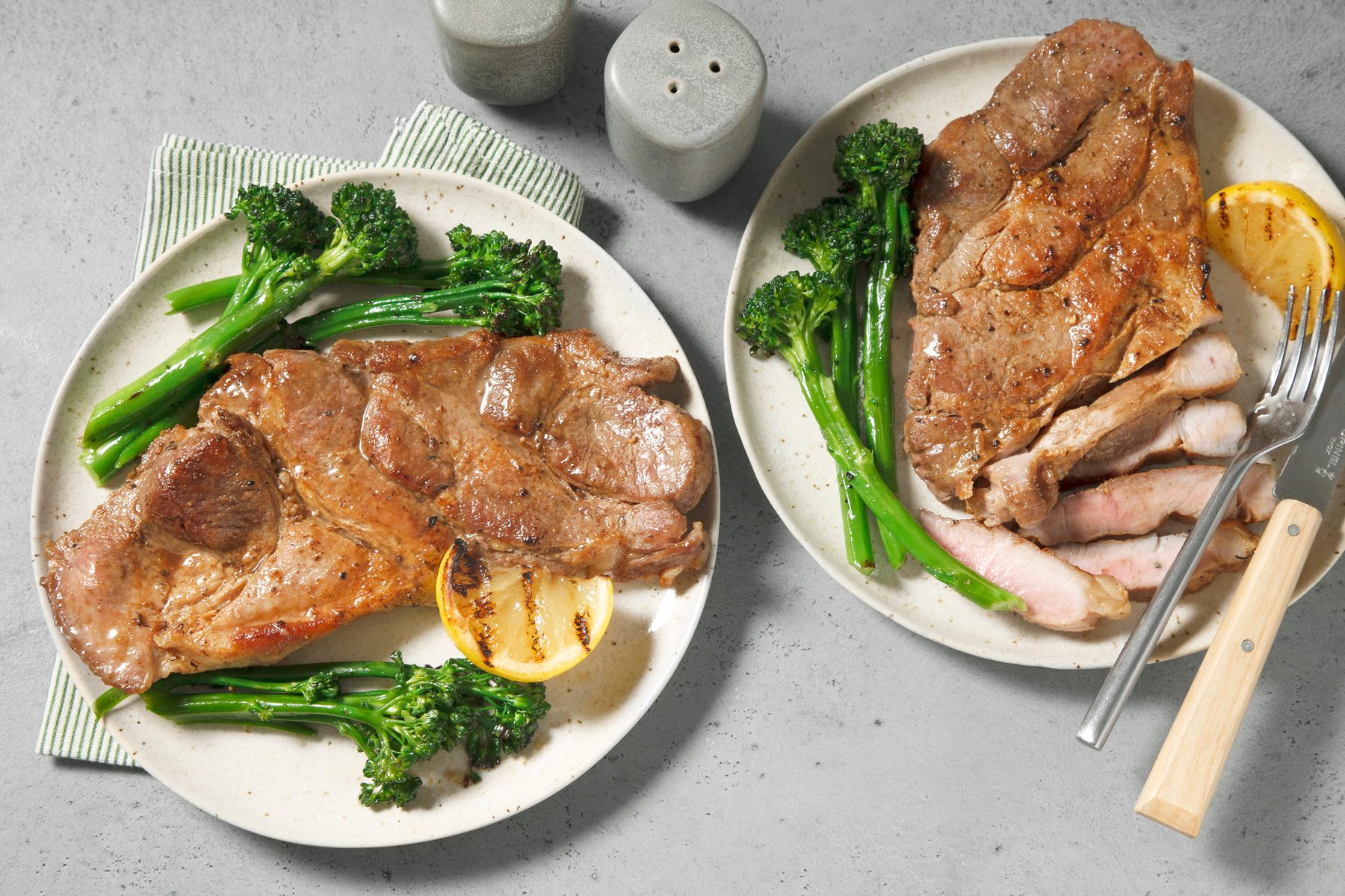 An overhead shot of pork steaks served on plates.