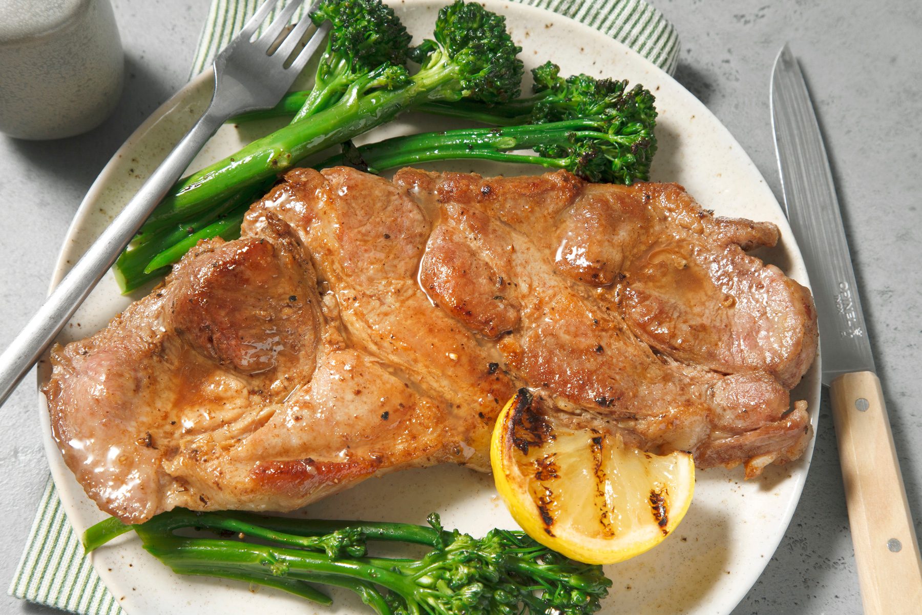An overhead shot of pork steak served on plate.