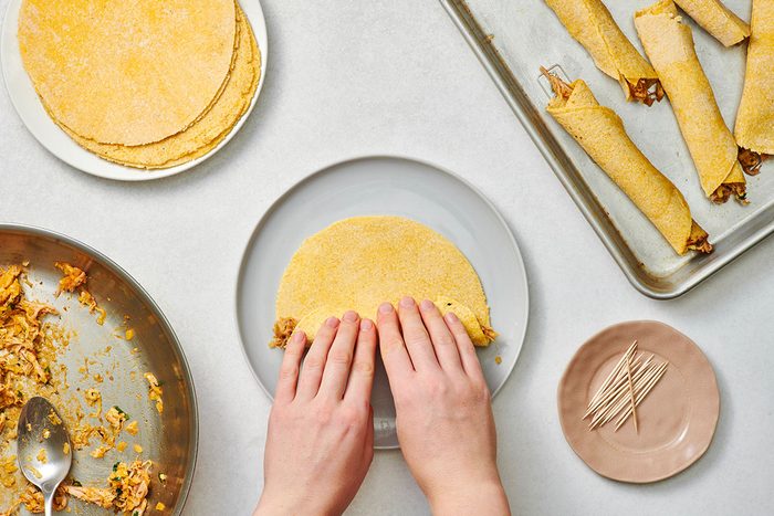 Assembling the pork taquitos