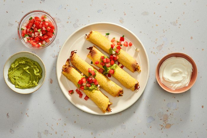 Taquitos served with guacamole pico de gallo and sour cream.