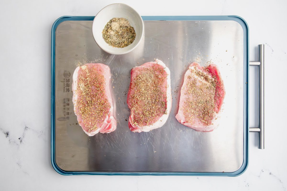 Overhead shot for Taste of Home Pork Chops and Noodles, pork chops resting with spices.