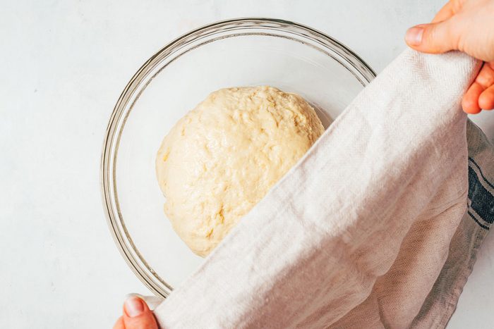 Covering the dough and letting rise in a greased bowl for the Potato Rolls Recipe for Taste of Home