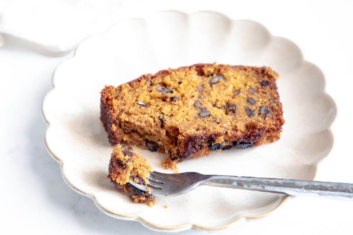 Beauty shot for Taste of Home Pumpkin Raisin Bread on a scalloped plate.