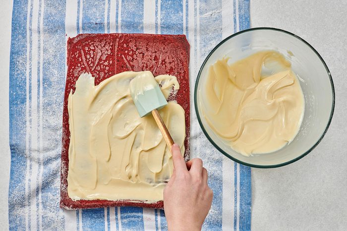 Spreading red velvet cake batter in a pan