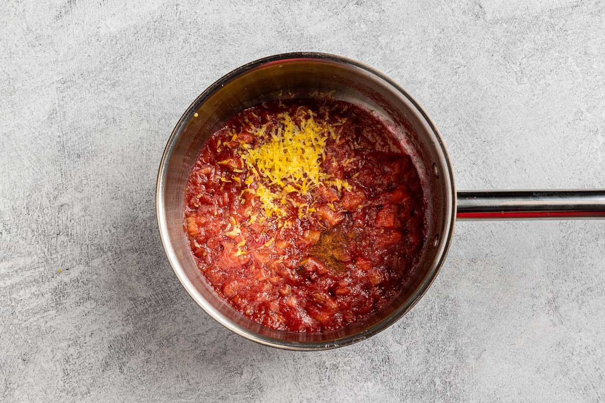 adding the lemon zest and nutmeg to the saucepan.